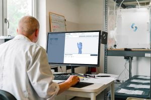 pay monthly website customisation options man in white dress shirt sitting in front of computer